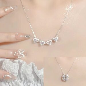 Elegant silver necklace with heart-shaped pendants and matching ring.