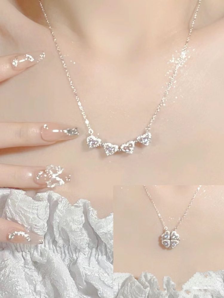 Elegant silver necklace with heart-shaped pendants and matching ring.