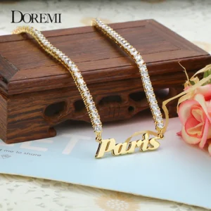 Elegant gold necklace with 'Thanks' pendant displayed on wooden box.