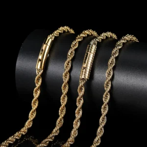 Four elegant gold chain necklaces displayed on a black cylindrical stand.
