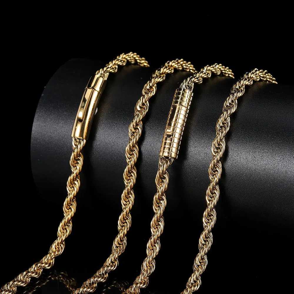 Four elegant gold chain necklaces displayed on a black cylindrical stand.