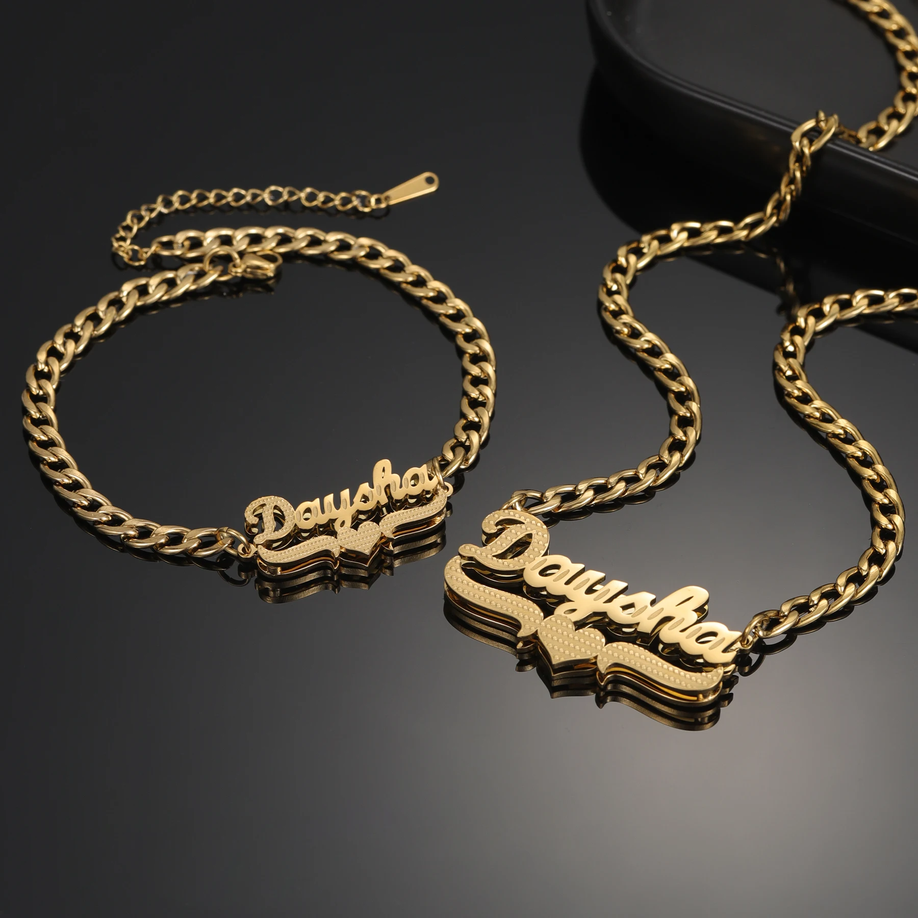 Gold chain necklace and bracelet with 'Dayak' name pendant.