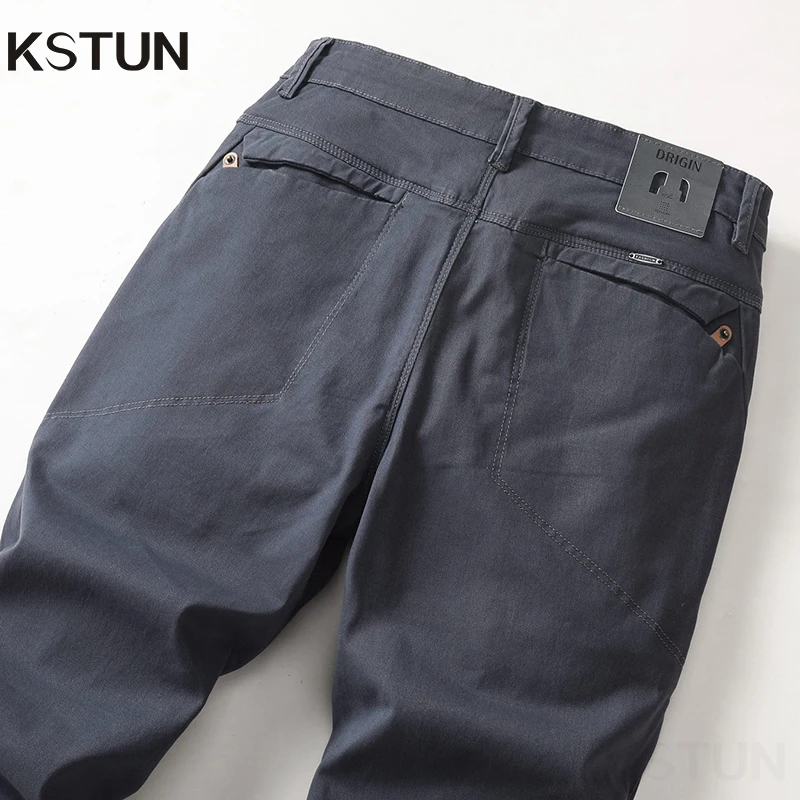 Dark gray pants with back pockets and belt loops.
