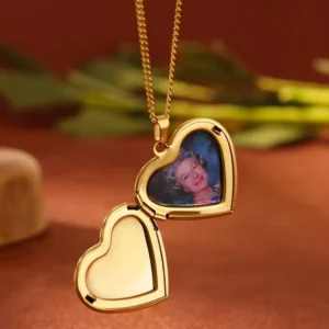 Gold heart-shaped locket necklace with a photo inside.