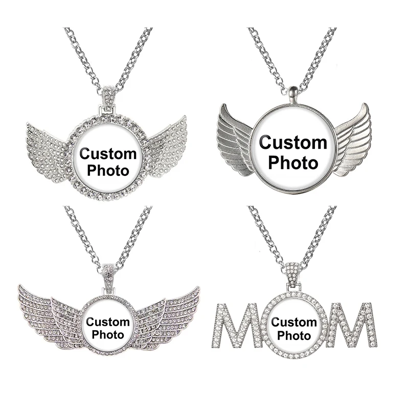 Four silver necklaces with winged designs and photo frames.