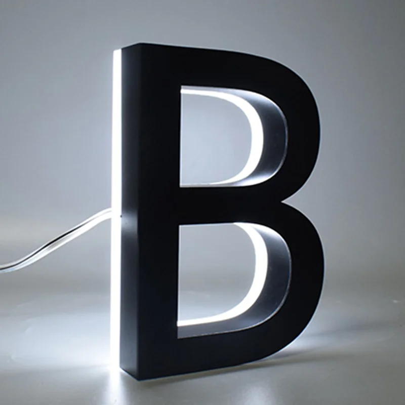 Illuminated black letter B with white light.