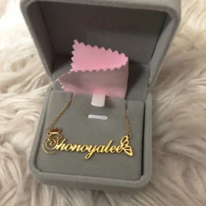Gold name necklace in a jewelry box.