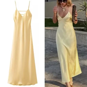 Elegant yellow satin slip dress with spaghetti straps.