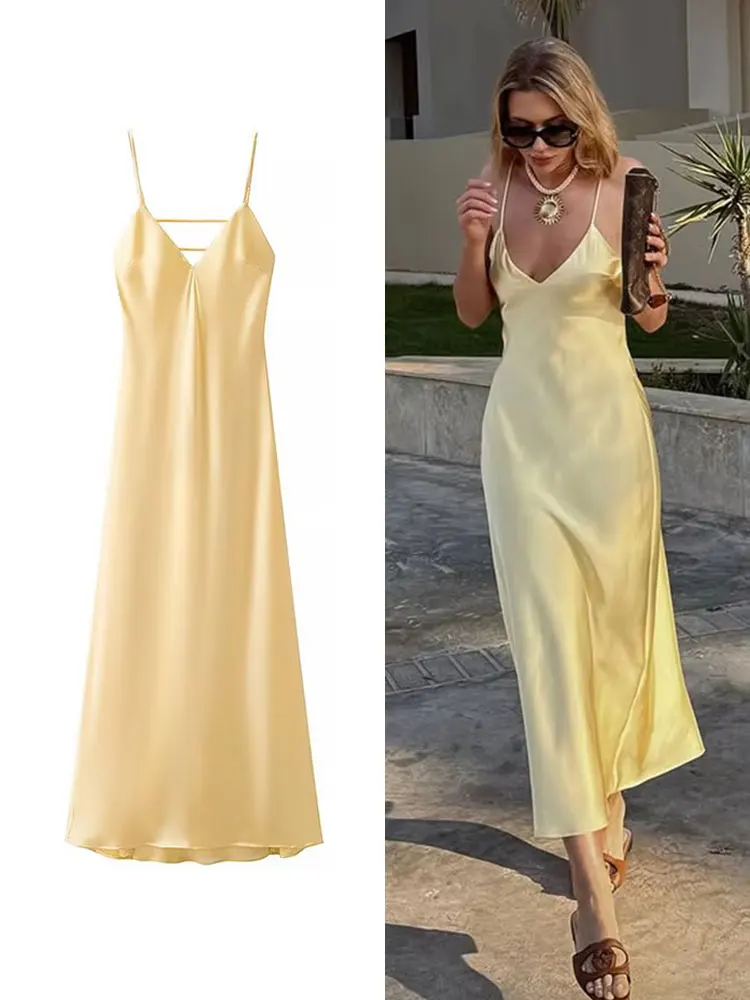 Elegant yellow satin slip dress with spaghetti straps.