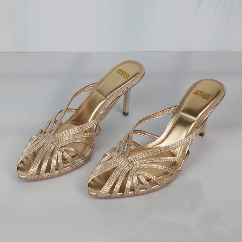 Elegant golden high-heeled sandals with a strappy design.