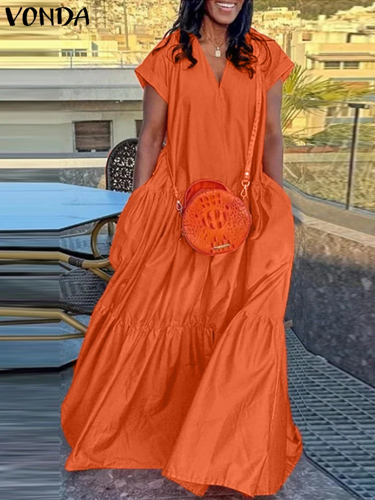 Orange dress with a round matching purse on a chair.