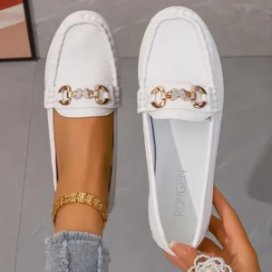 Elegant white loafers with gold chain detail.