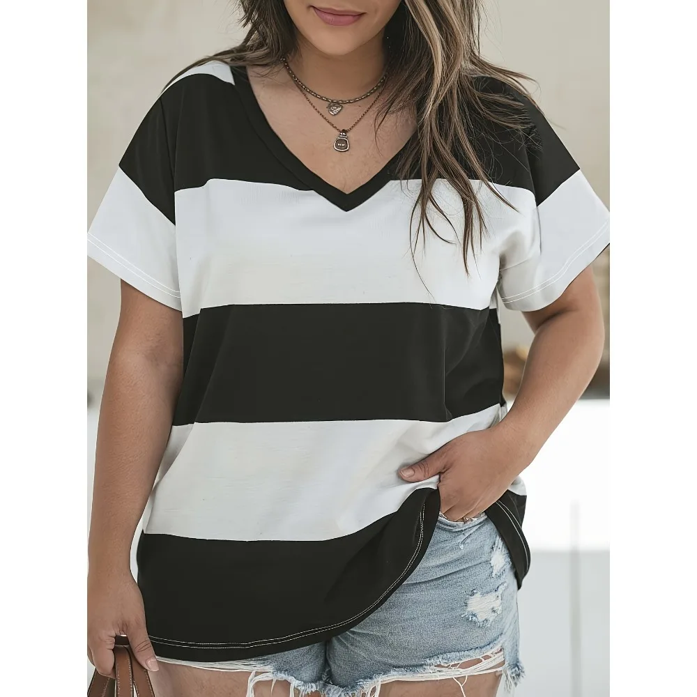 Woman wearing a black and white striped v-neck t-shirt with denim shorts.