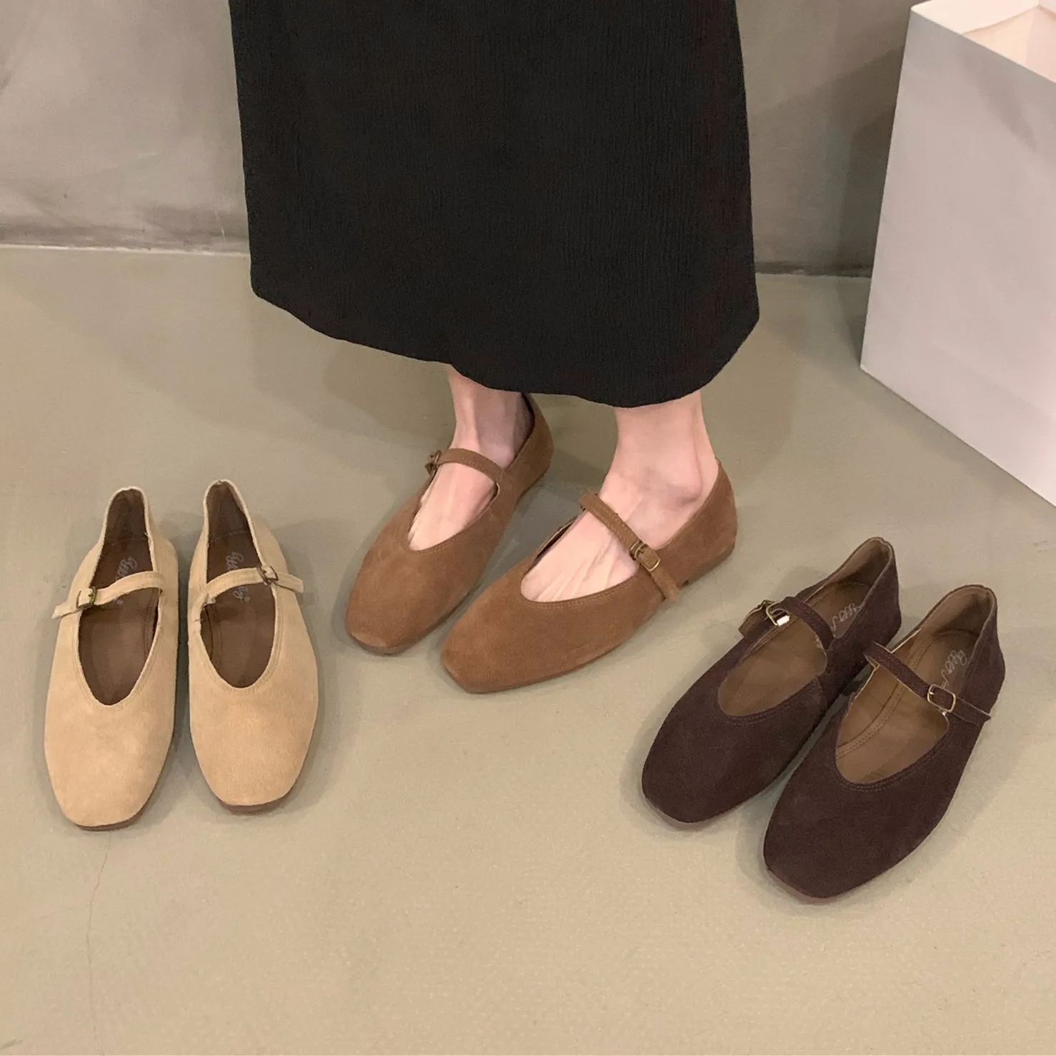 Three pairs of stylish Mary Jane shoes in beige, brown, and dark brown.
