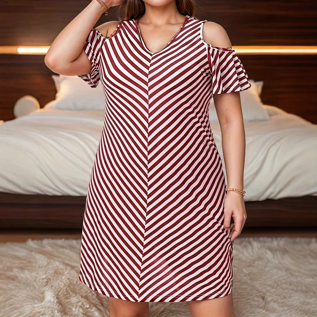 Woman wearing a red and white striped cold-shoulder dress.