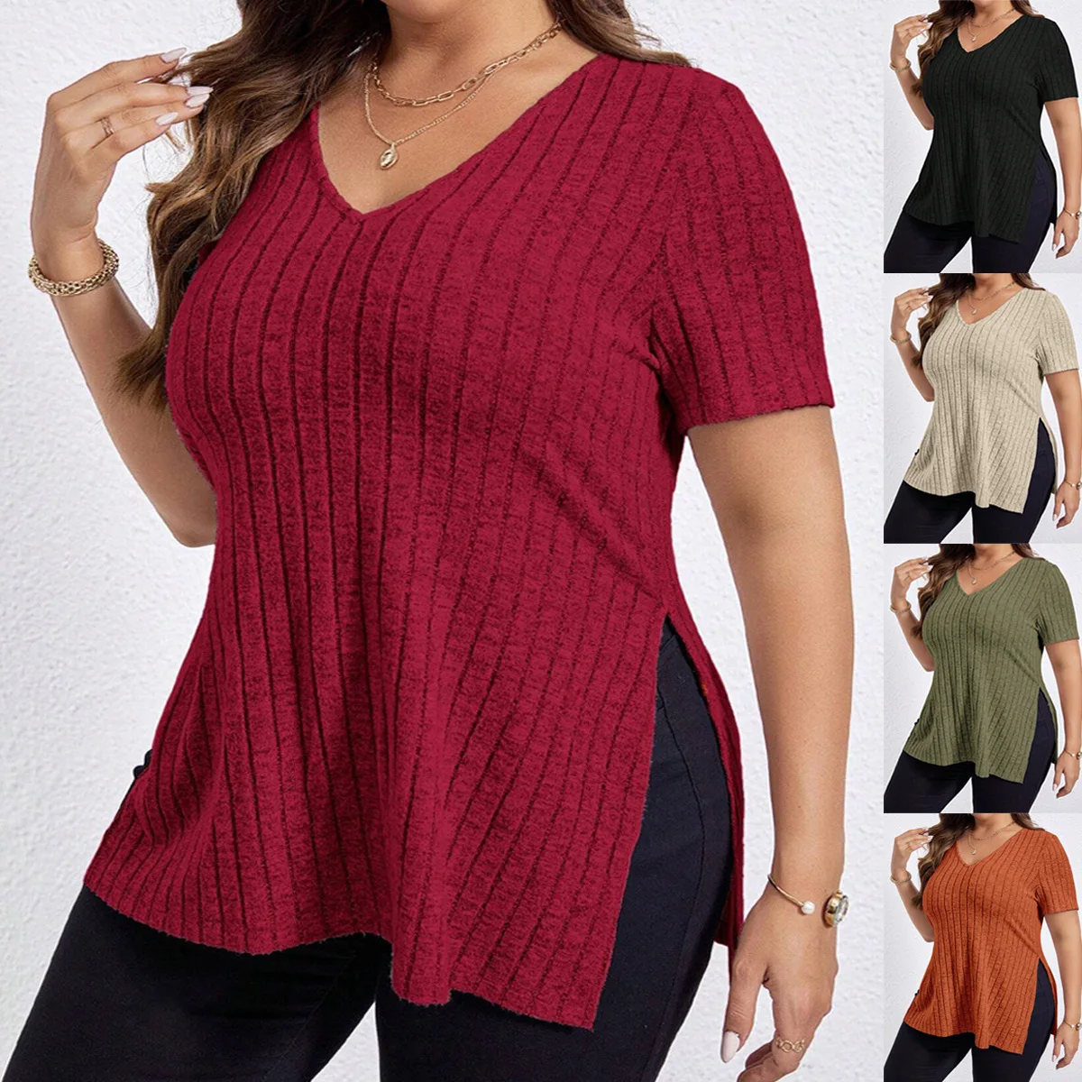 Woman wearing a red ribbed short-sleeve top with side slits.