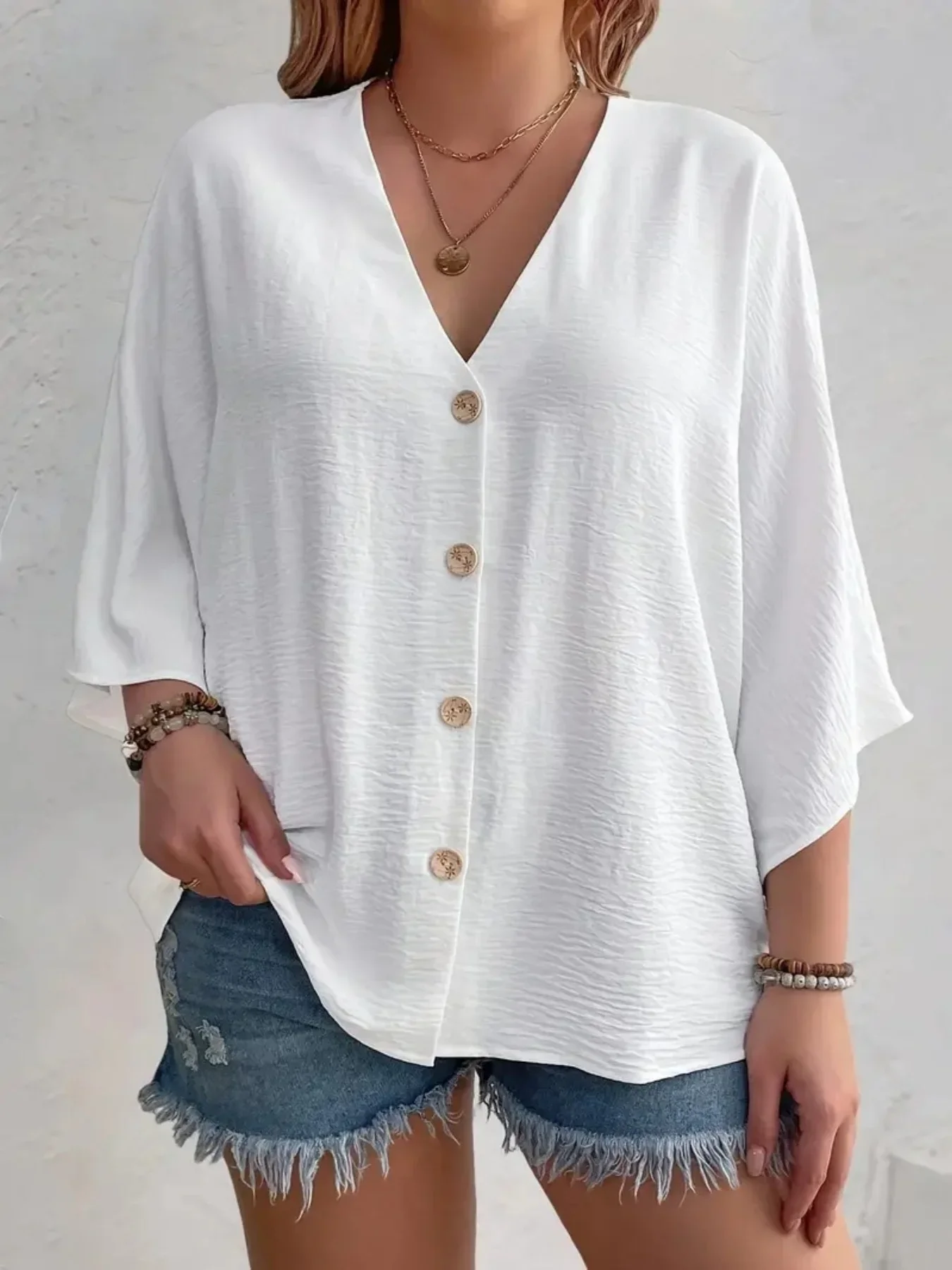 White button-up blouse with loose sleeves and casual fit.