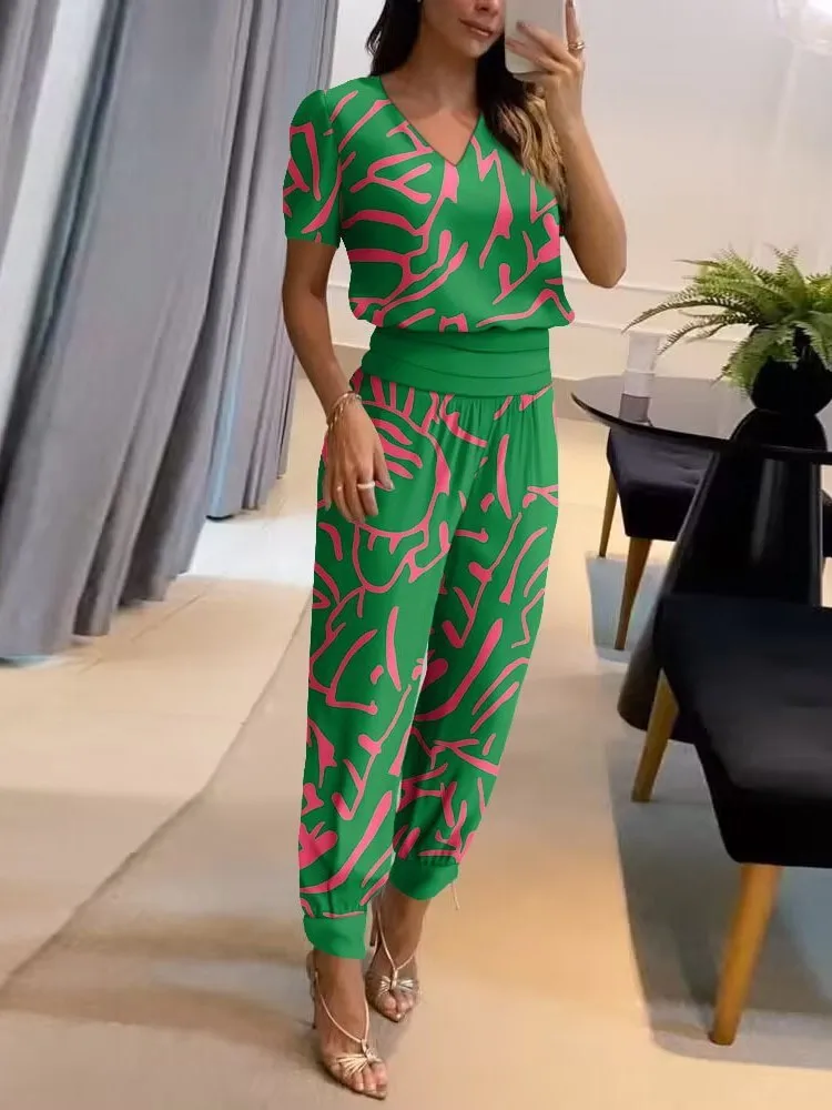 Person wearing a green outfit with pink patterns.