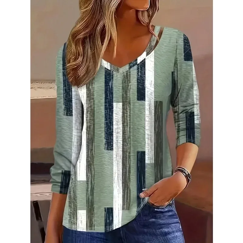 Woman wearing a striped long-sleeve top with jeans.
