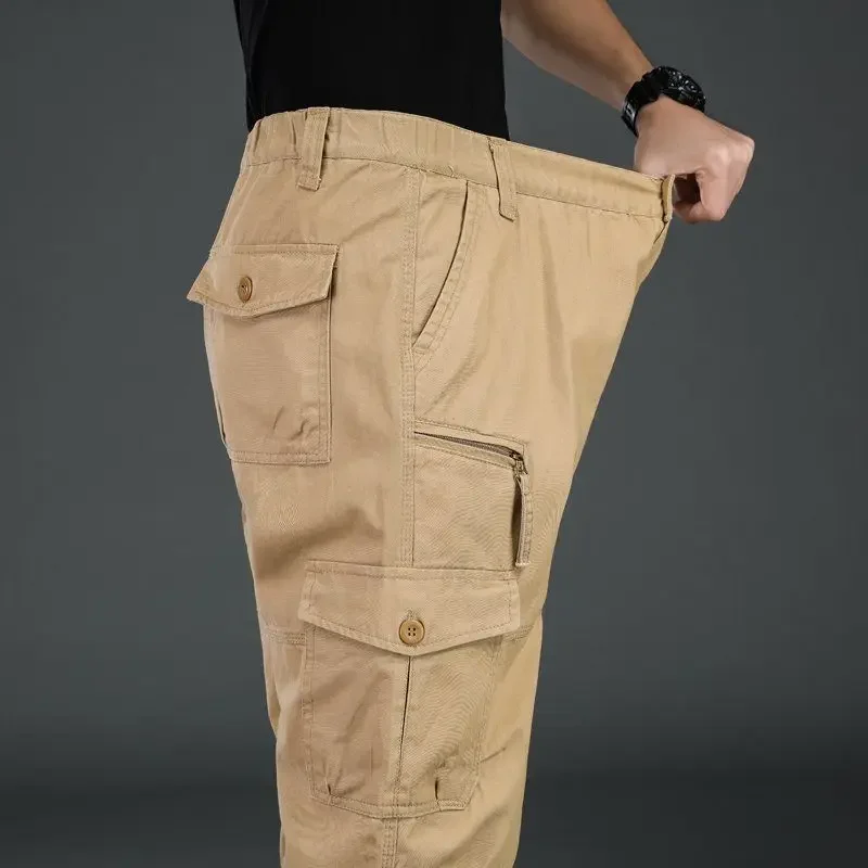 Person holding out oversized beige cargo pants.