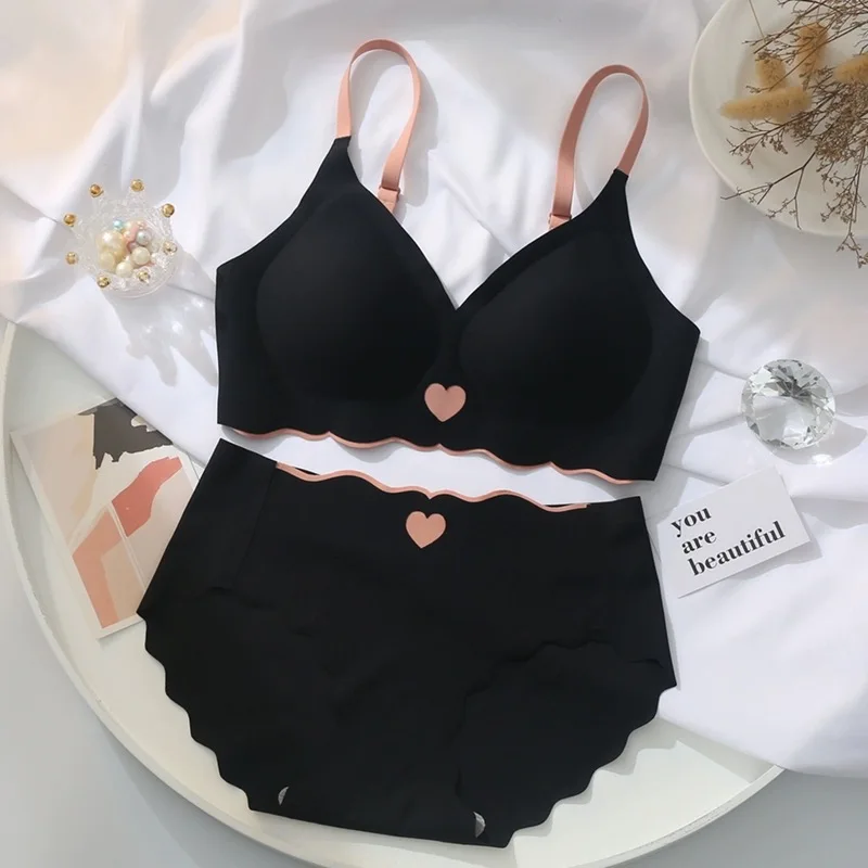 Black scalloped lingerie set with heart details and pink straps.