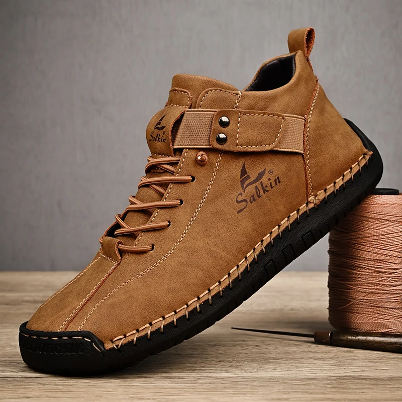 Brown casual suede shoes with black soles and detailed stitching.