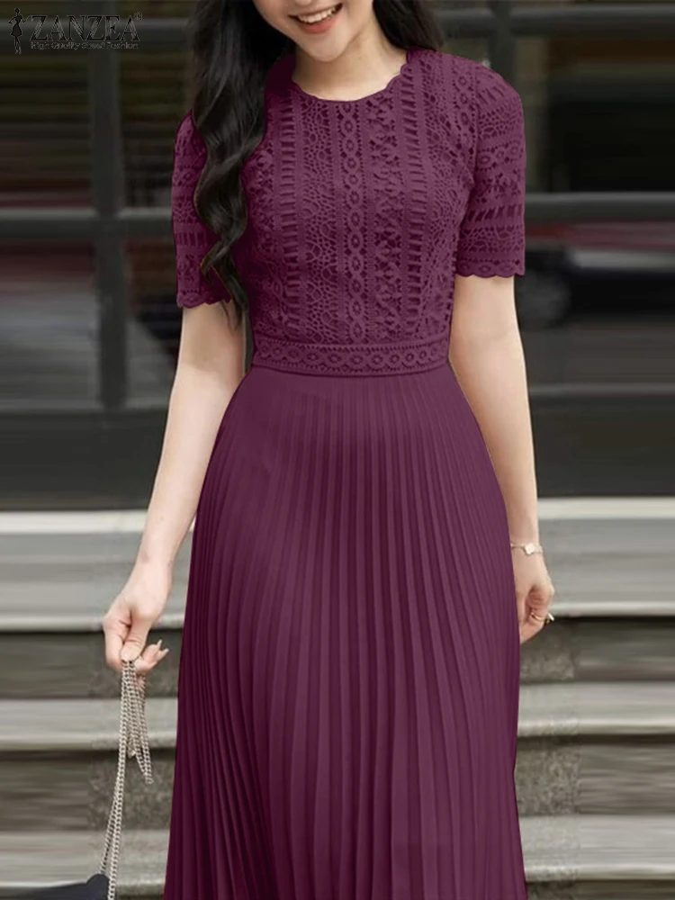 Elegant woman in a purple pleated dress holding a small handbag.
