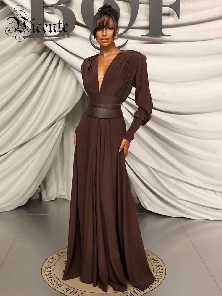Elegant long brown dress with a deep V-neck and cinched waist.