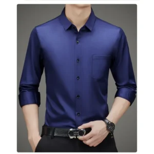 Man wearing a sleek navy blue dress shirt with rolled-up sleeves.