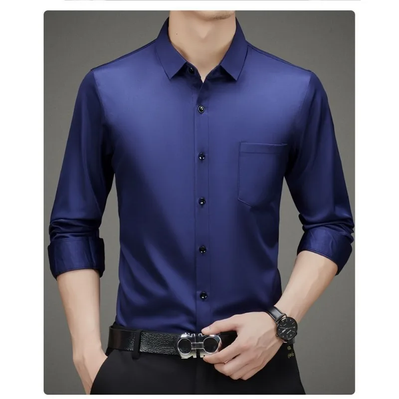 Man wearing a sleek navy blue dress shirt with rolled-up sleeves.
