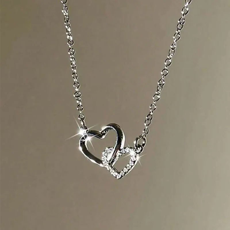 Interlocking heart necklace with sparkling diamonds.