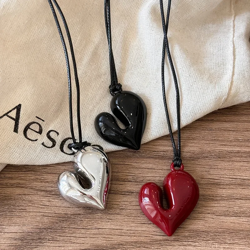 Heart-shaped pendants in black, silver, red.
