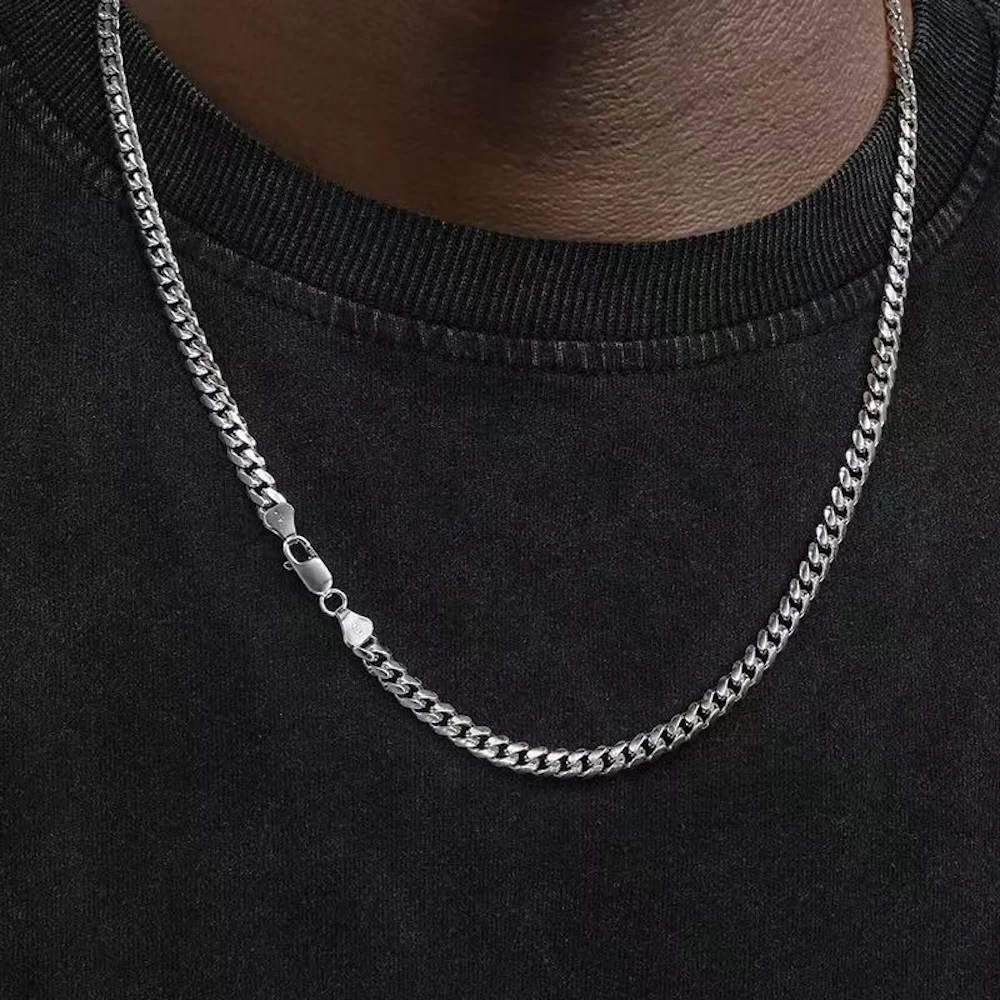 Silver chain necklace on black shirt.