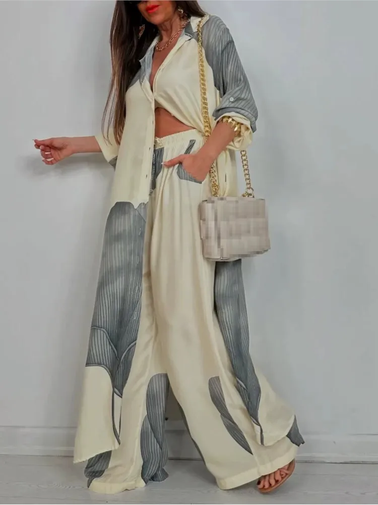 Woman wearing a flowing, color-blocked maxi dress with long sleeves.