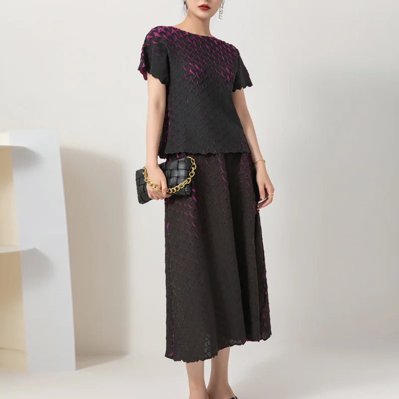 Woman in a black midi dress holding a clutch purse.