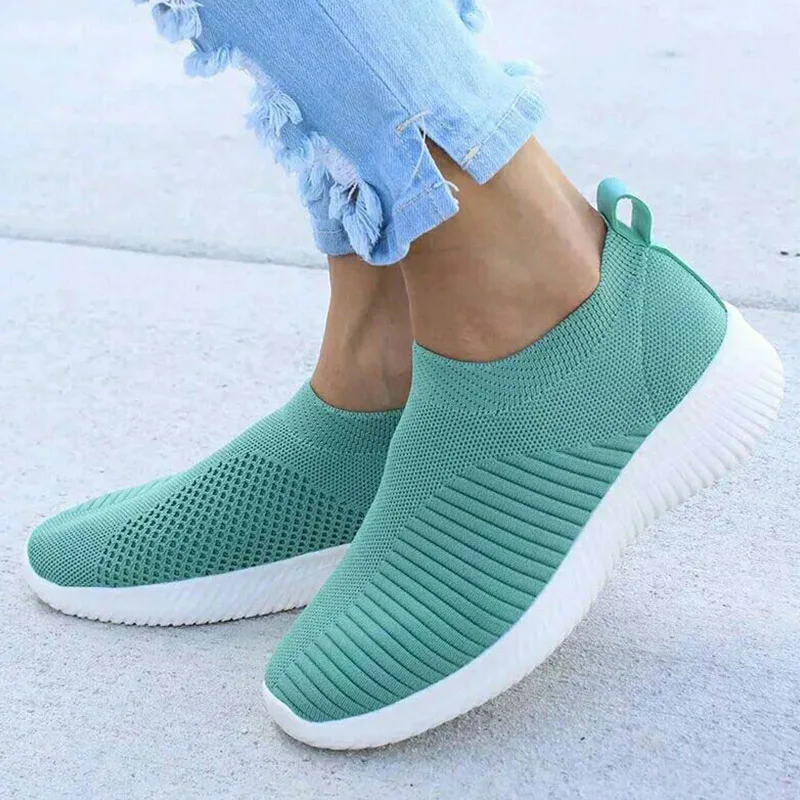 Casual teal slip-on sneakers with white soles.
