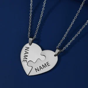 Heart-shaped puzzle piece necklace on chains.