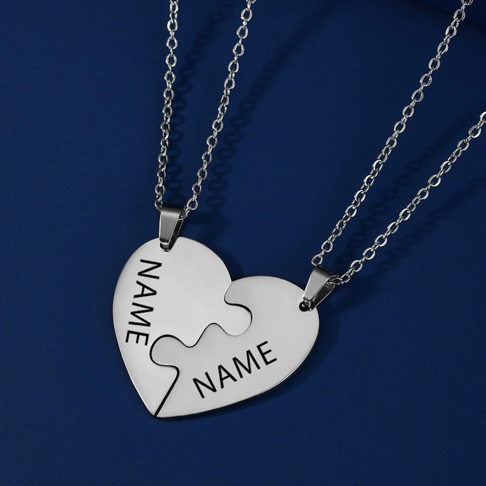Heart-shaped puzzle piece necklace on chains.