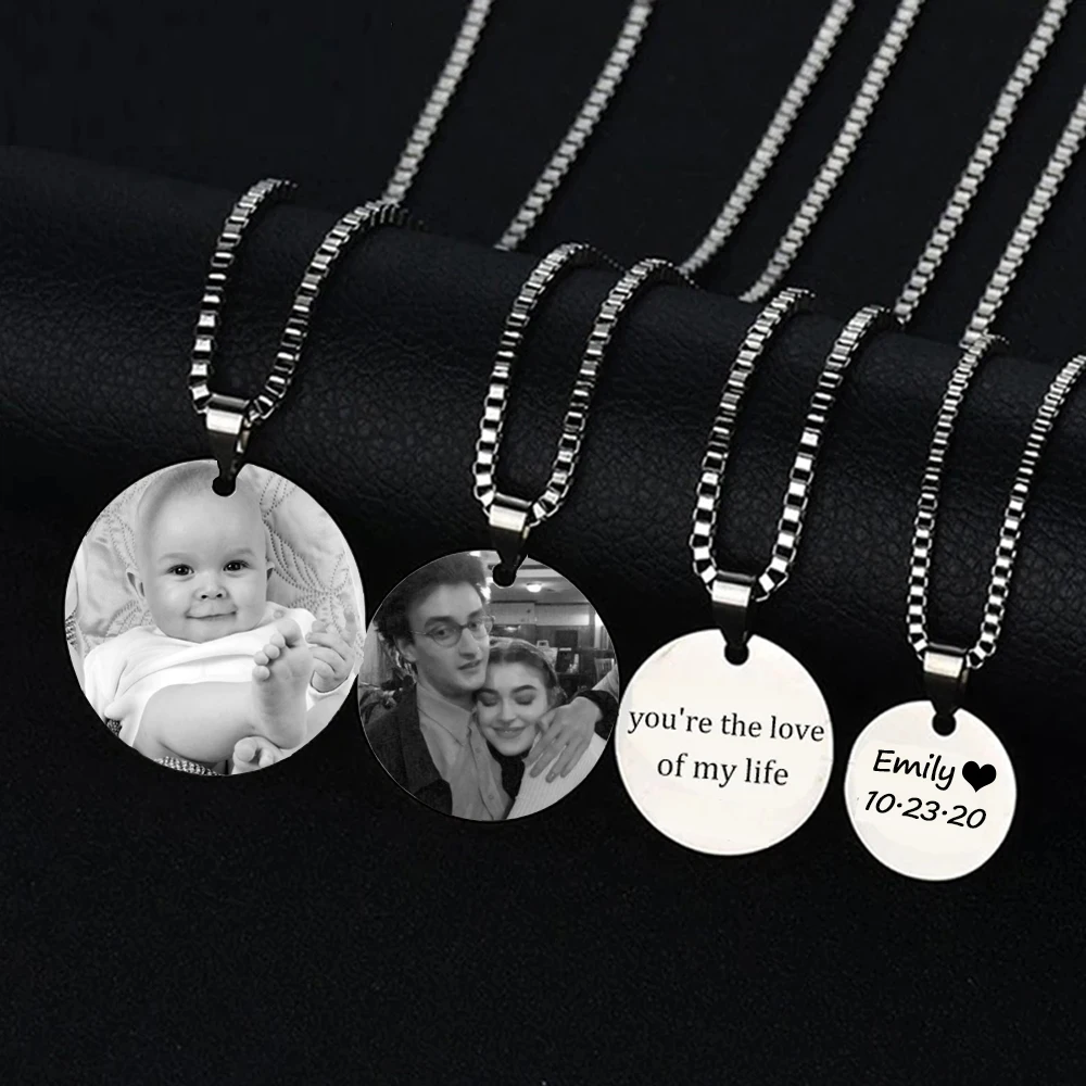 Four personalized photo necklaces on display.