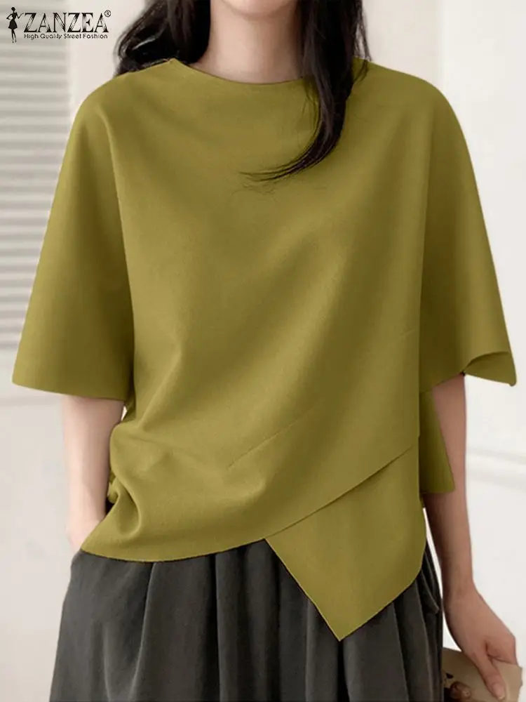 Woman wearing an olive green asymmetrical short-sleeve top.