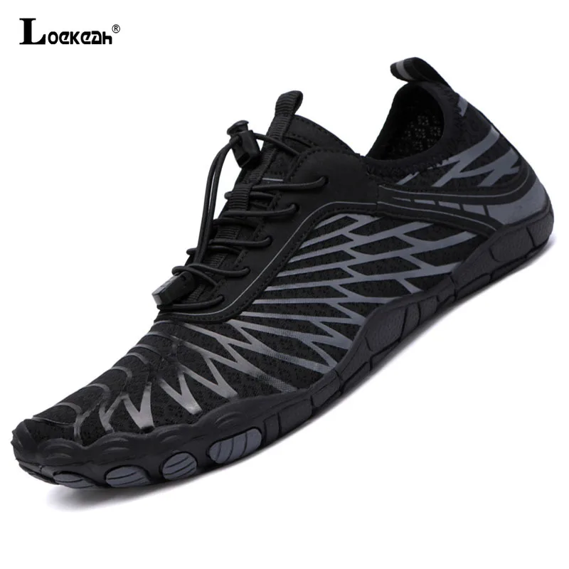 Black minimalist barefoot shoe with geometric pattern and flexible sole.