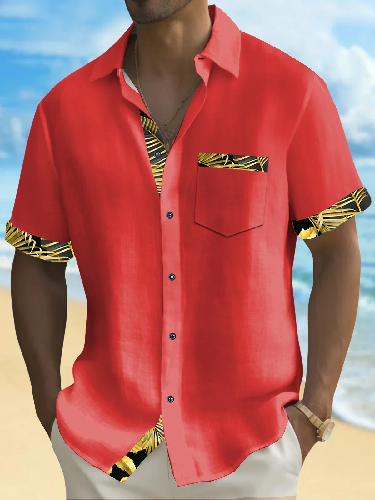 A person wearing a vibrant red short-sleeve shirt with patterned trim.