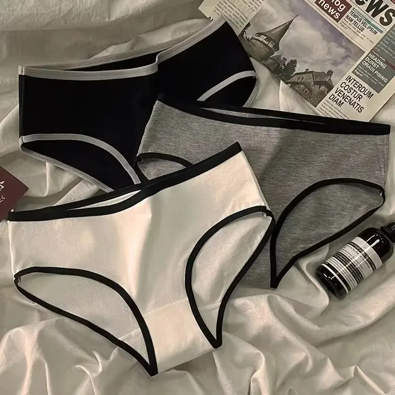 Three pairs of women's underwear in black, gray, and white with black trim.
