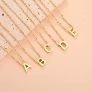 Gold necklaces with alphabet letter pendants A, B, C, D, E.