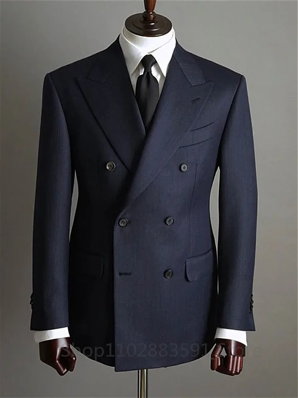 Dark double-breasted suit on mannequin.
